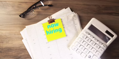 now hiring sticky note with a calendar and calculator