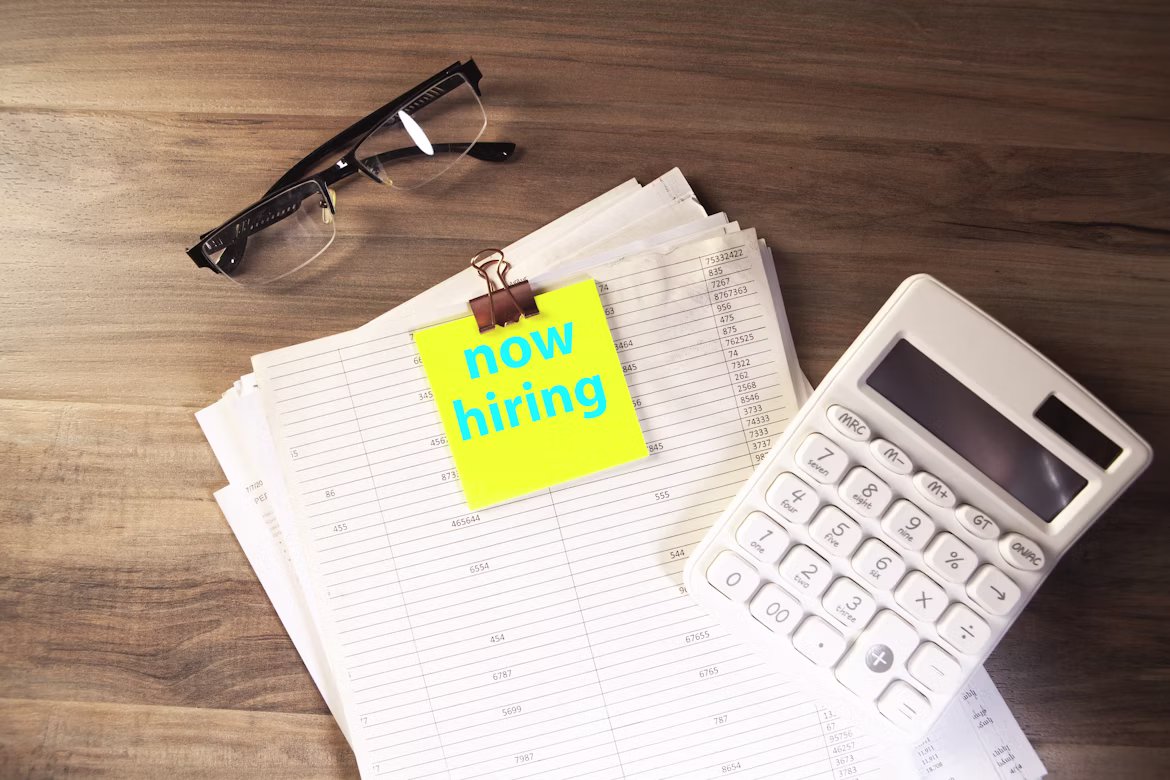 now hiring sticky note with a calendar and calculator