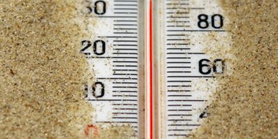 a hot thermometer buried in the sand on a summer day to emulate the heat felt when not implementing nonprofit retention strategies